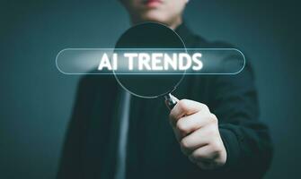 Businessman hand use magnifying glass Search for Ai Trends information. Using Search Console for Trends data, info, Searching On Virtual Screen Data Search Technology Search Engine Optimization. photo