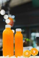 Fresh orange juice and cut half orange slice on ice cube. photo