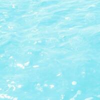 abstract blue swimming pool water background and sun light photo