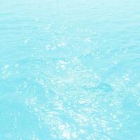 abstract blue swimming pool water background and sun light photo