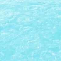 abstract blue swimming pool water background and sun light photo