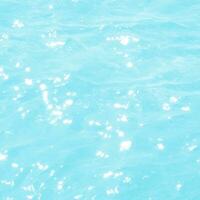 abstract blue swimming pool water background and sun light photo