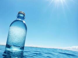 Abstract blue water background with liquid fresh fluid in bottle. photo