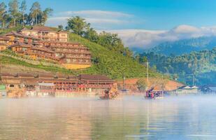 Chinese boat launched early in the morning at Rak Thai hamlet in Maehongson, Thailand, on the lake with water vapor, Banrakthai, Ban rak thai. photo