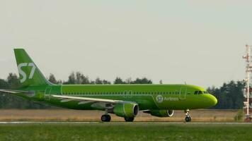 KAZAN, RUSSIA AUGUST 05, 2022 - Airbus A320 of S7 airlines speed up before takeoff at Kazan airport. Jet airplane on the airfield on a summer day. Tourism and travel concept video