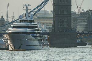 Cruise ship moored on Thames river with Tower bridge in background photo