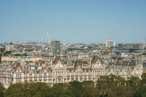 The Royal Horseguards hotel amidst buildings in city on sunny day photo