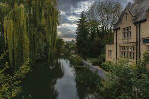 Exterior of The Oxford Retreat pub building by river and trees photo