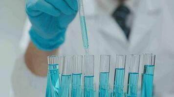 Health care researchers working in life science laboratory. Young female research scientist and senior male supervisor preparing and analyzing microscope slides in research lab. video