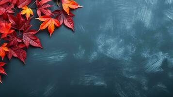 Autumn background with colored red leaves on blue slate background top view copy space photo