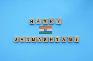 September 6, happy Krishna Janmashtami, flag of India, minimalistic banner with inscription in wooden letters photo