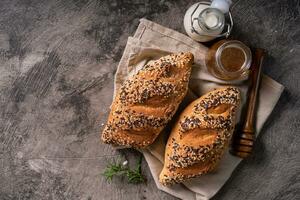 Fresh homemade bread whole wheat baguette on napkin and abstract table. Sourdough bread photo