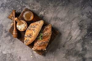 Fresh homemade bread whole wheat baguette on napkin and abstract table. Sourdough bread photo