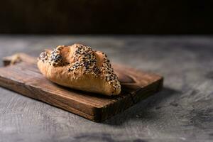 Fresh homemade bread whole wheat baguette on napkin and abstract table. Sourdough bread photo