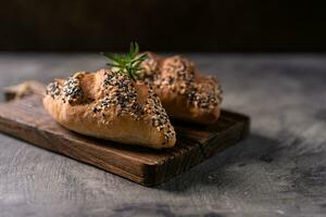 Fresh homemade bread whole wheat baguette on napkin and abstract table. Sourdough bread photo