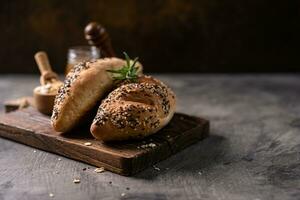 Fresh homemade bread whole wheat baguette on napkin and abstract table. Sourdough bread photo