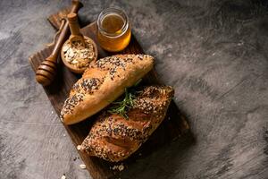 Fresh homemade bread whole wheat baguette on napkin and abstract table. Sourdough bread photo