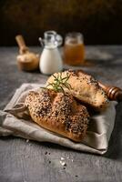 Fresh homemade bread whole wheat baguette on napkin and abstract table. Sourdough bread photo