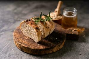 Artisan bread whole wheat baguette white milk and honey on rustic wooden board and abstract table. Sourdough bread photo