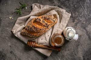 Fresh homemade bread whole wheat baguette on napkin and abstract table. Sourdough bread photo