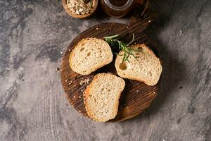 Artisan bread whole wheat baguette white milk and honey on rustic wooden board and abstract table. Sourdough bread photo