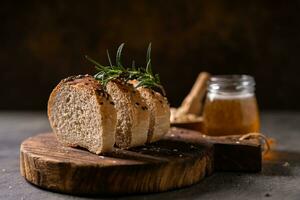 Artisan bread whole wheat baguette white milk and honey on rustic wooden board and abstract table. Sourdough bread photo