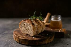 Artisan bread whole wheat baguette white milk and honey on rustic wooden board and abstract table. Sourdough bread photo