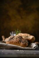 Fresh homemade bread whole wheat baguette on napkin and abstract table. Sourdough bread photo