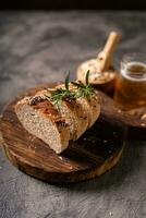 Artisan bread whole wheat baguette white milk and honey on rustic wooden board and abstract table. Sourdough bread photo
