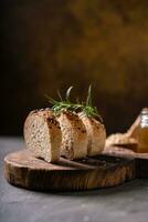 Artisan bread whole wheat baguette white milk and honey on rustic wooden board and abstract table. Sourdough bread photo