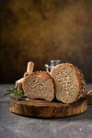 Artisan bread whole wheat baguette white milk and honey on rustic wooden board and abstract table. Sourdough bread photo