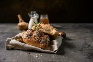 Fresh homemade bread whole wheat baguette on napkin and abstract table. Sourdough bread photo