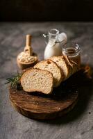 Artisan bread whole wheat baguette white milk and honey on rustic wooden board and abstract table. Sourdough bread photo