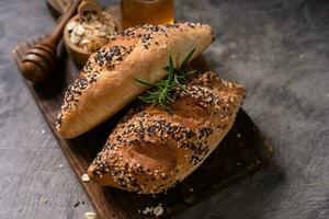 Fresh homemade bread whole wheat baguette on napkin and abstract table. Sourdough bread photo