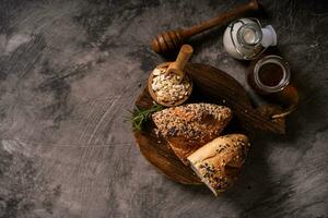 Artisan bread whole wheat baguette white milk and honey on rustic wooden board and abstract table. Sourdough bread photo