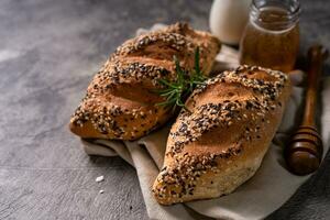 Fresh homemade bread whole wheat baguette on napkin and abstract table. Sourdough bread photo