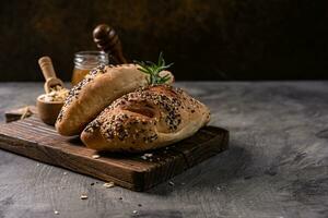 Fresh homemade bread whole wheat baguette on napkin and abstract table. Sourdough bread photo