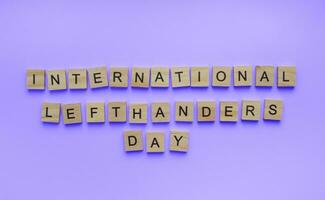 August 13, International Day of Lefties, Lefthanders Day, minimalistic banner with the inscription in wooden letters photo