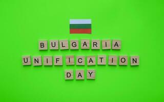 September 6, Unification Day in Bulgaria, flag of Bulgaria, minimalistic banner with the inscription in wooden letters on a green background photo