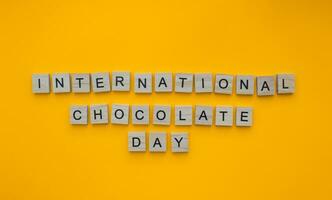 September 13, International Chocolate Day, minimalistic banner with the inscription in wooden letters photo