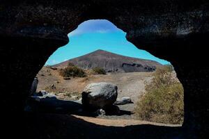 un ver de un montaña mediante un arco foto