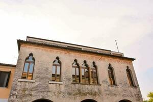 a building with arched windows and a balcony photo