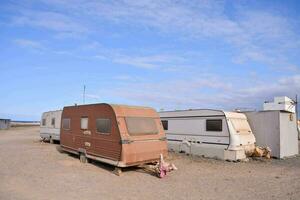 a caravan park with several trailers parked in the dirt photo