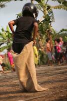 Magelang Indonesia.08 05 2023- sack race during indonesia independence day photo