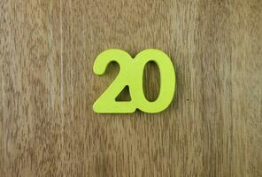 Number twenty on wooden background photo