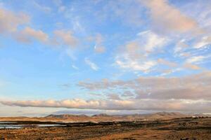 a view of the ocean and mountains from a hill photo