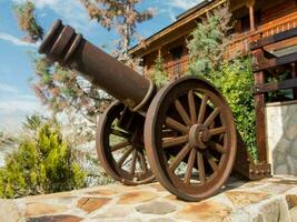 an old cannon is on display outside of a house photo