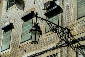 a street lamp on a building with a window photo
