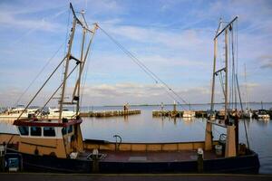 a fishing boat docked at the dock photo