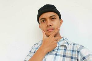 Man wearing pajamas and beanie cap smiling while looking at camera. Isolated on white background photo